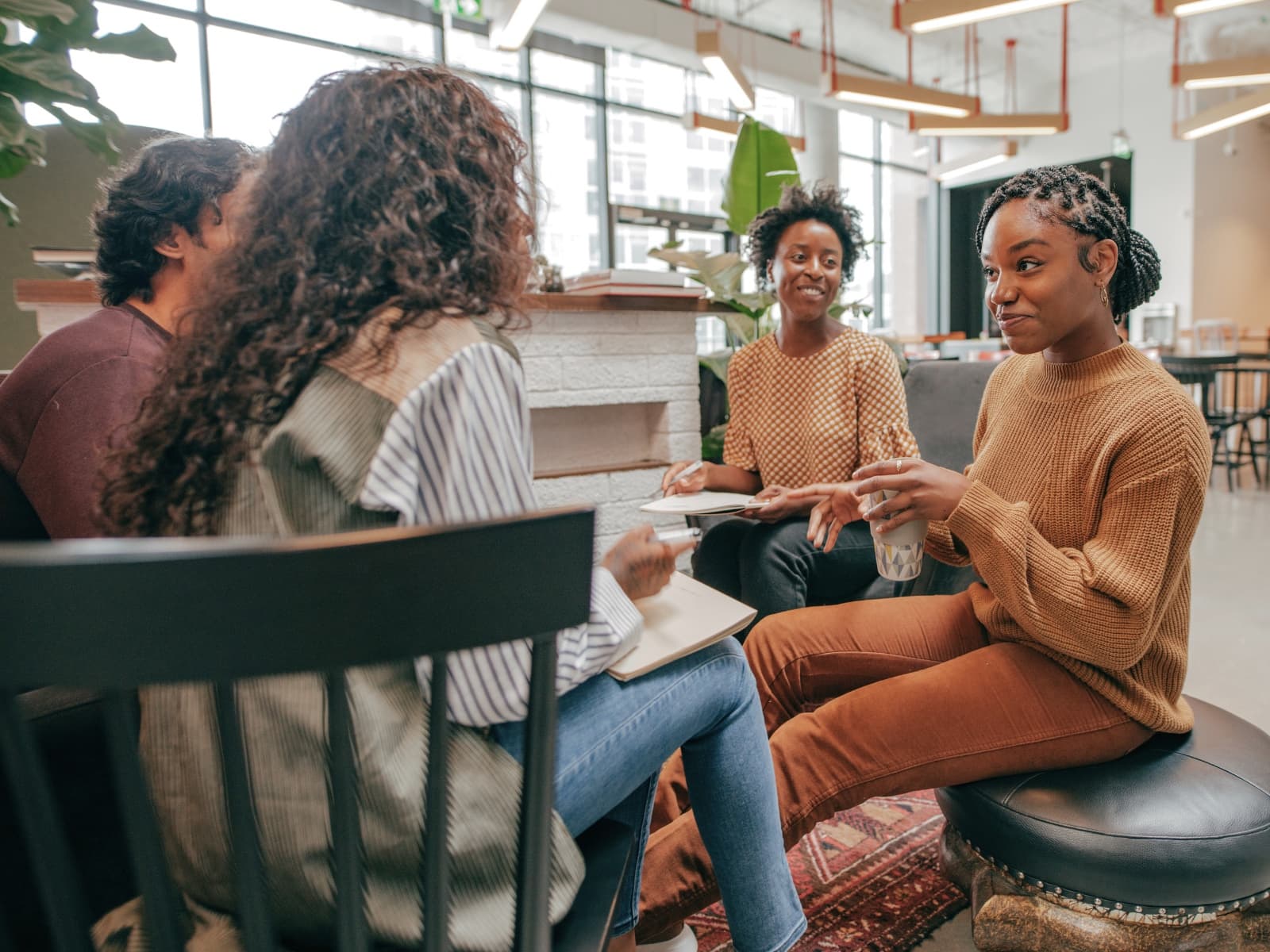 A small group in thoughtful conversation around a kitchen table
